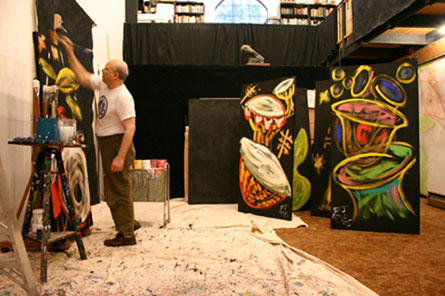 Artist E.J. Gold painting in his studio